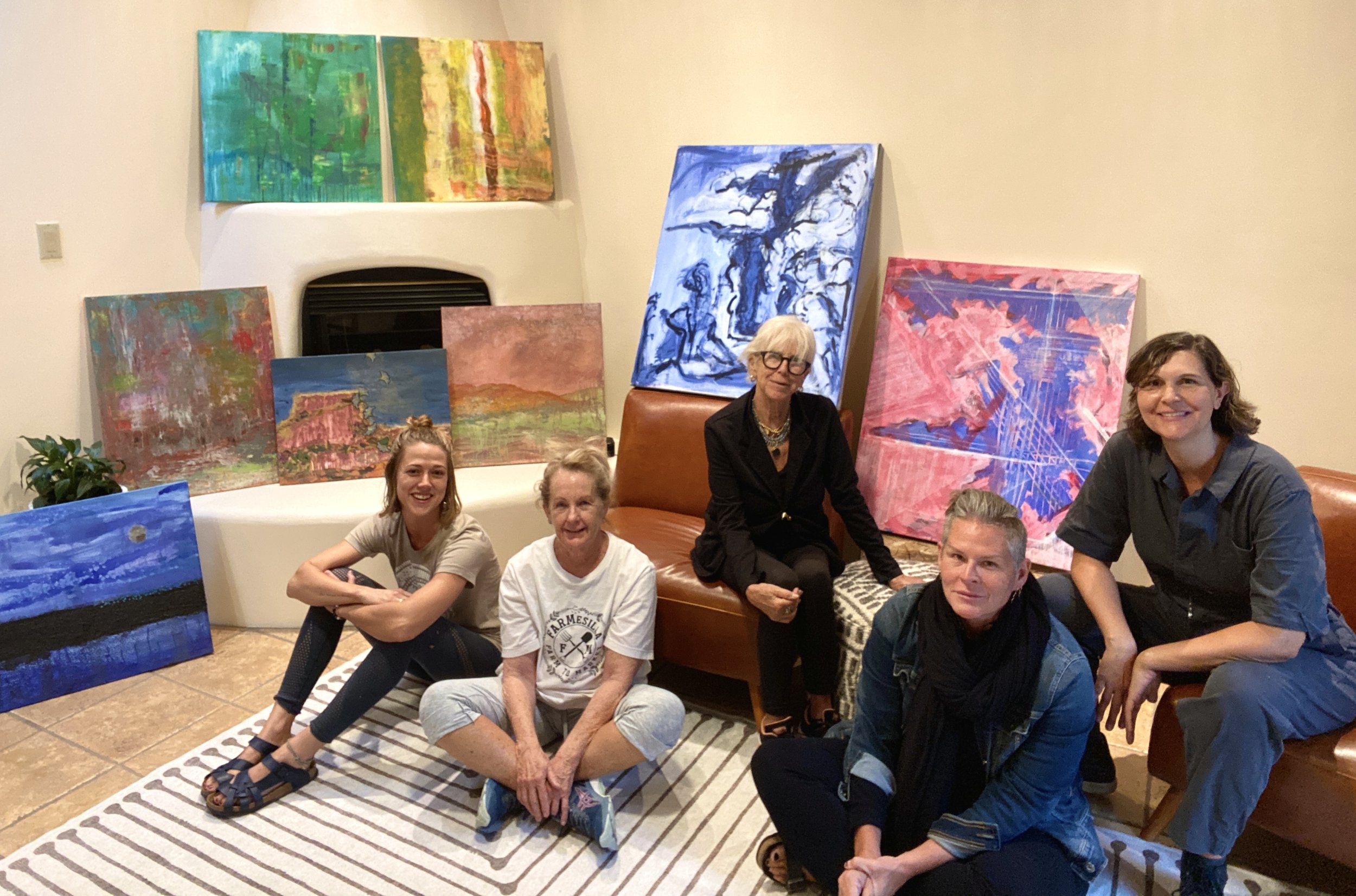 students displaying their paintings after their painting retreat 